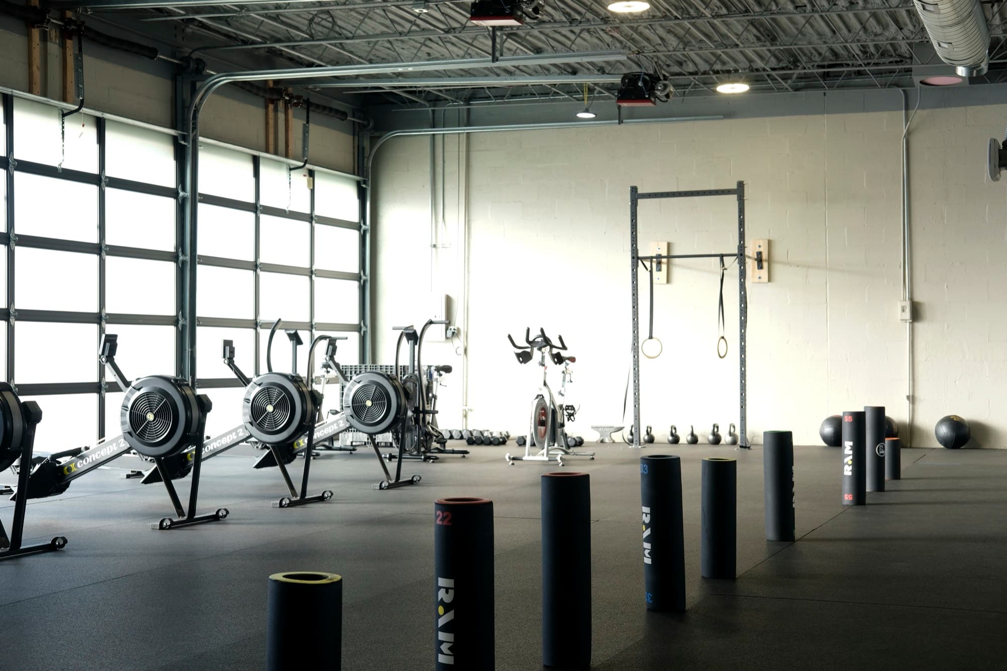 The main floor at Fitness 300 with racks, benches and the turf lane