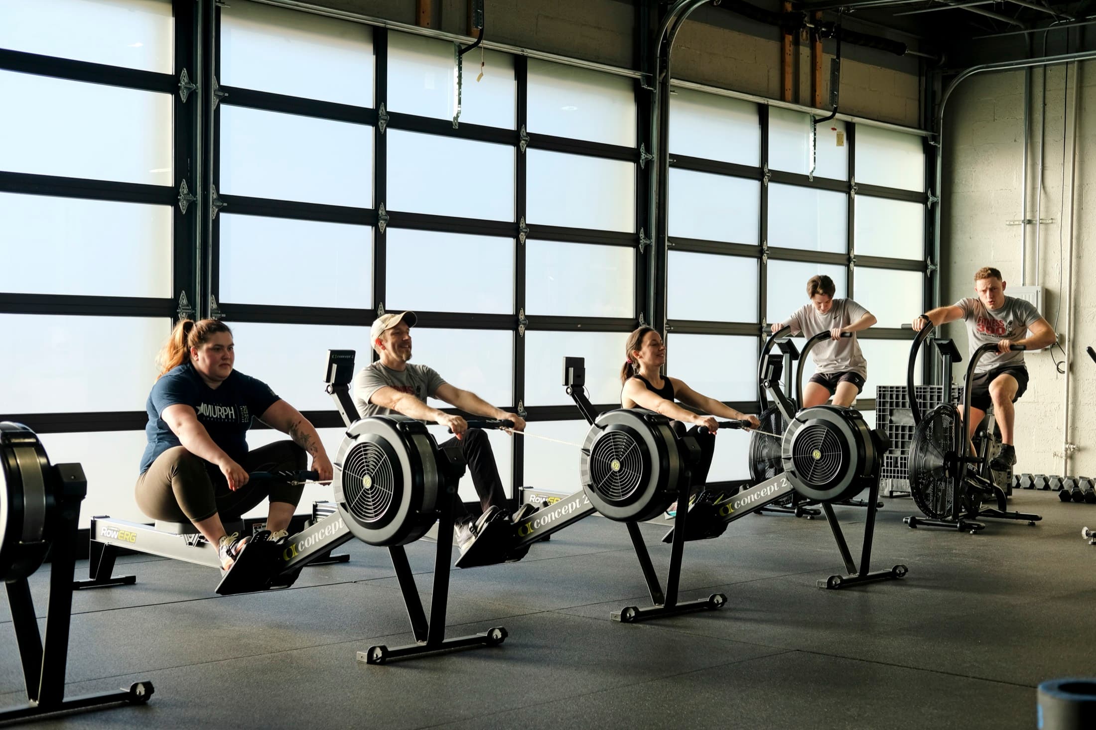 Members training on Concept2 rowers in the main bay at Fitness 300 in Huntsville, Alabama
